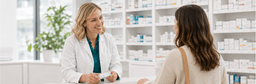 Rexall pharmacist speaking with a customer